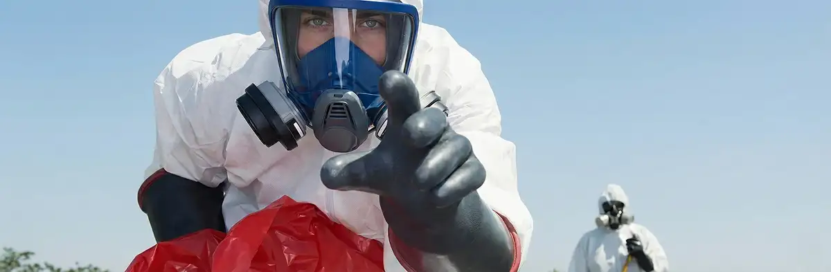 sewage clean up technician wearing protective gear handling biohazard materials in Baltimore, MD