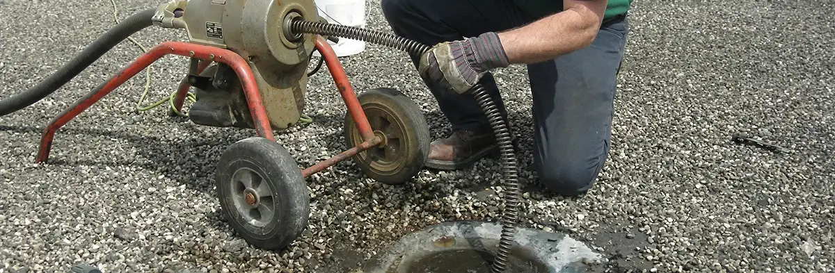 sewer rodding technician actively removing blockages from a sewer line in Baltimore, MD