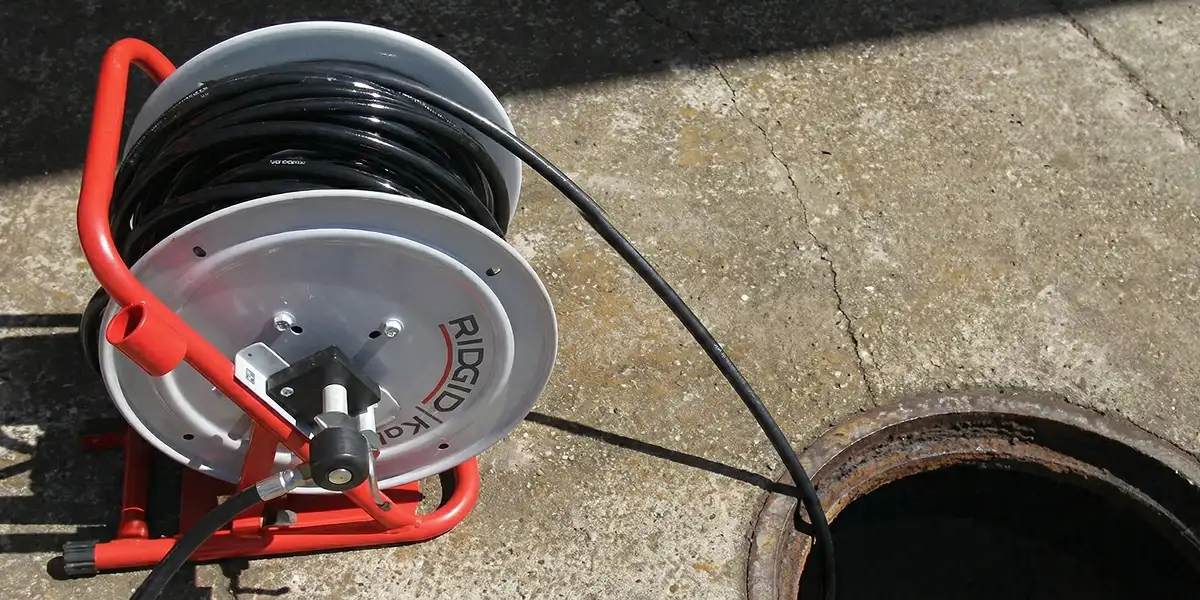 sewer rodding equipment prepared to clear clogged sewer lines in Baltimore, MD